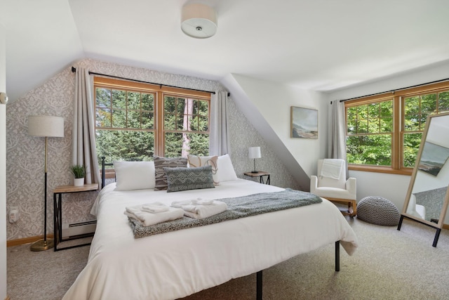 bedroom with vaulted ceiling, baseboard heating, and carpet floors