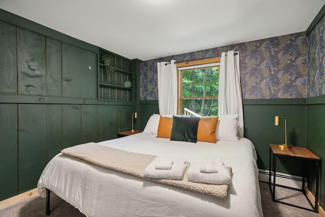 bedroom featuring baseboard heating and dark carpet