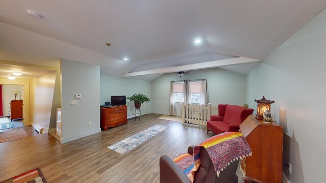 living room featuring light hardwood / wood-style flooring and vaulted ceiling