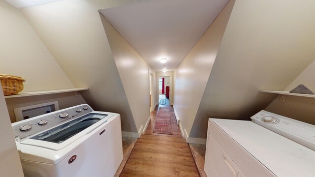 laundry room with light hardwood / wood-style flooring and washer and dryer