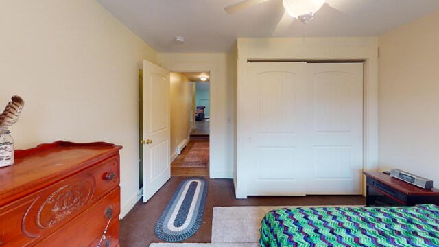 bedroom with a closet, ceiling fan, and dark hardwood / wood-style flooring