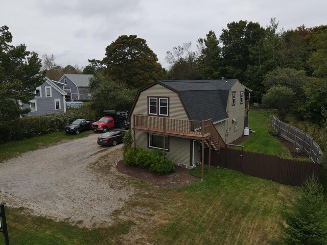 view of front facade featuring a front lawn and a deck