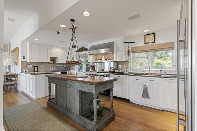12 Steamboat Wharf Ln, Harpswell, ME 04079 - kitchen with white cabinets, backsplash, extractor fan, and a sink
