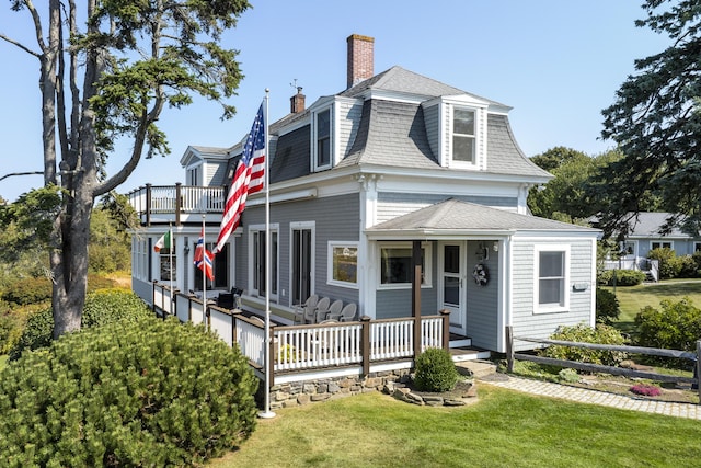 12 Steamboat Wharf Ln, Harpswell, ME 04079 - view of front of house with mansard roof, a chimney, a shingled roof, and a front lawn