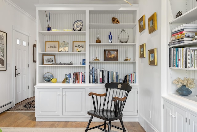 12 Steamboat Wharf Ln, Harpswell, ME 04079 - sitting room with a baseboard heating unit, ornamental molding, built in shelves, and light wood finished floors