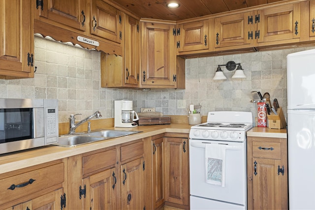 12 Steamboat Wharf Ln, Harpswell, ME 04079 - kitchen with a sink, backsplash, brown cabinets, and white appliances