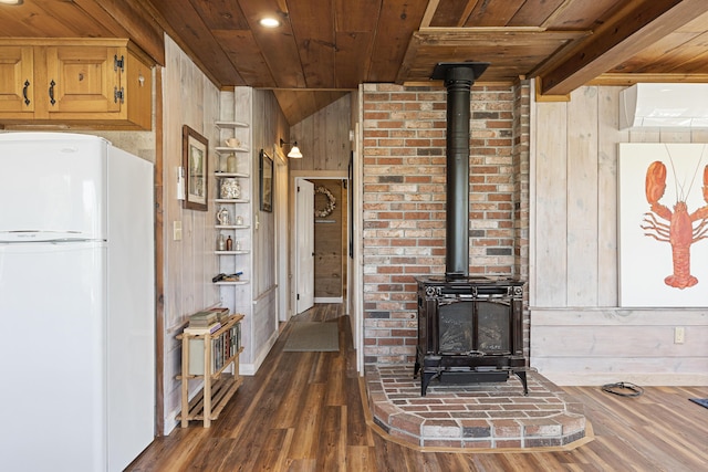 12 Steamboat Wharf Ln, Harpswell, ME 04079 - unfurnished living room featuring wood ceiling, a wall unit AC, a wood stove, wood walls, and dark wood-type flooring