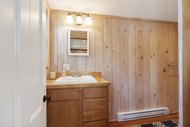12 Steamboat Wharf Ln, Harpswell, ME 04079 - bathroom featuring wooden walls, vanity, and a baseboard radiator