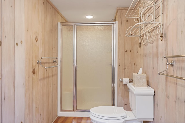 12 Steamboat Wharf Ln, Harpswell, ME 04079 - bathroom featuring wood walls, a stall shower, and toilet