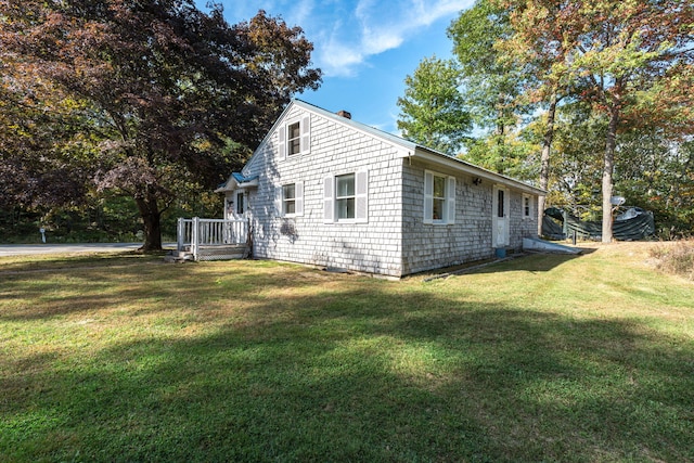 view of side of home with a lawn