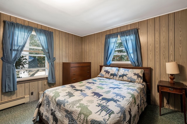 bedroom with carpet floors, wood walls, and baseboard heating