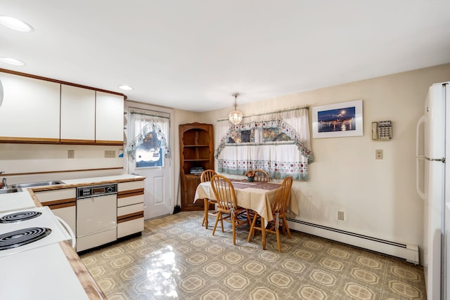 kitchen with light countertops, a sink, white cabinetry, baseboard heating, and white appliances