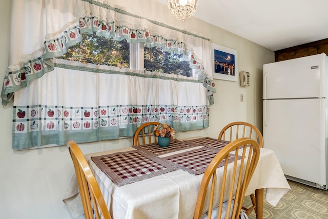 dining area featuring a notable chandelier