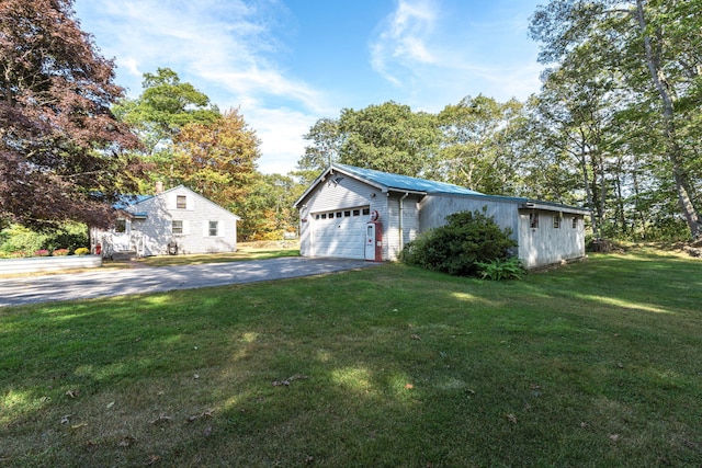 exterior space featuring driveway and a front lawn