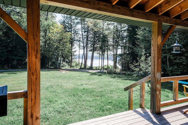 view of yard with a deck with water view