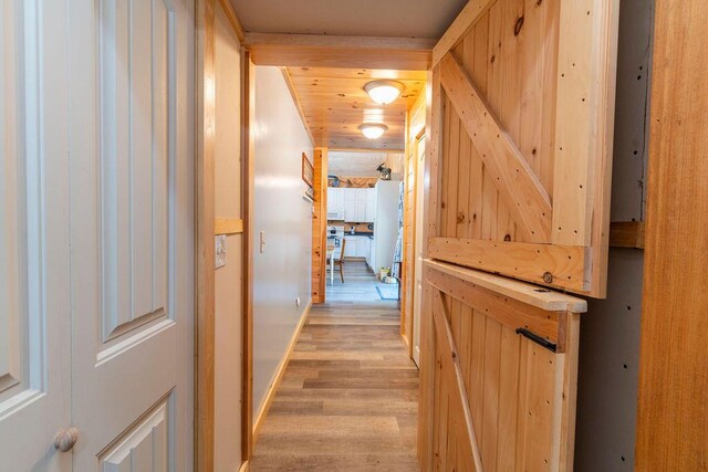 corridor with light hardwood / wood-style flooring