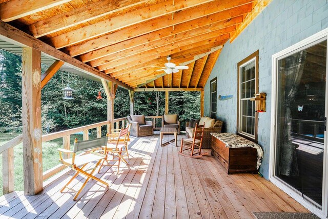 wooden terrace with outdoor lounge area and ceiling fan