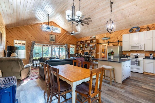 dining area featuring wood ceiling, high vaulted ceiling, ceiling fan with notable chandelier, wood walls, and dark hardwood / wood-style floors