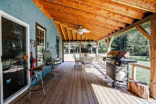 wooden terrace featuring area for grilling and ceiling fan