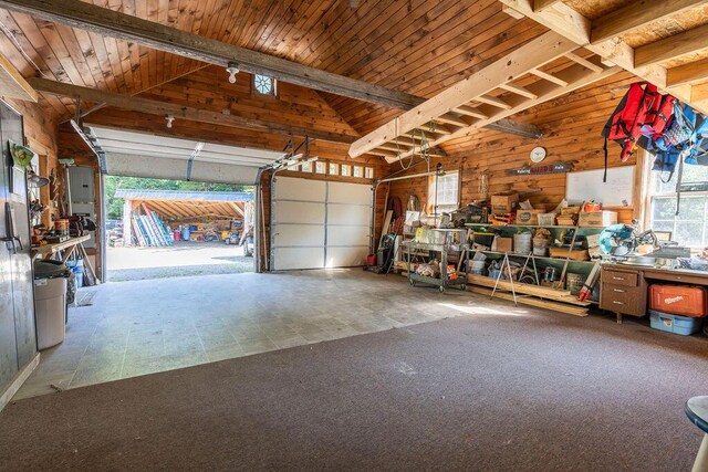 garage featuring wooden ceiling, wood walls, and electric panel