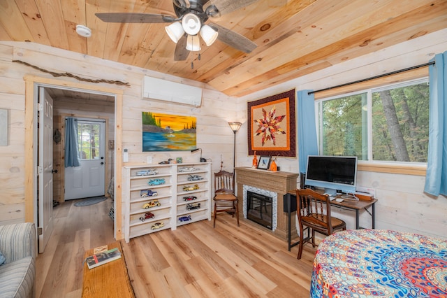 office space with light wood-type flooring, vaulted ceiling, wooden walls, a wall mounted AC, and ceiling fan