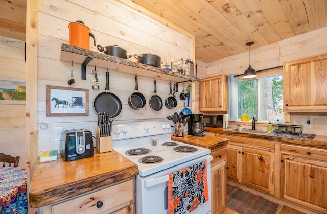 kitchen featuring wood walls, electric range, and decorative light fixtures