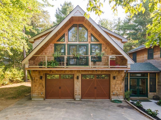 view of front facade with a balcony and a garage