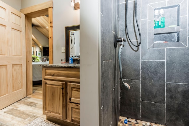 bathroom with walk in shower, vanity, and wood-type flooring