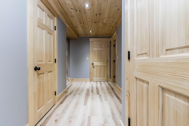 hall with wood ceiling and light hardwood / wood-style floors