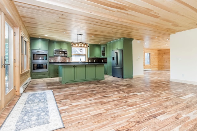 kitchen with a wealth of natural light, light wood-type flooring, stainless steel appliances, green cabinets, and decorative light fixtures