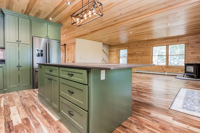 kitchen with pendant lighting, wood ceiling, light hardwood / wood-style floors, a wood stove, and green cabinetry