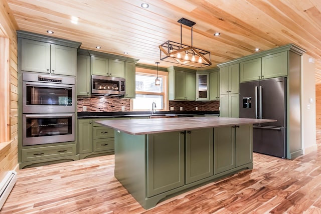 kitchen featuring green cabinets, appliances with stainless steel finishes, and hanging light fixtures