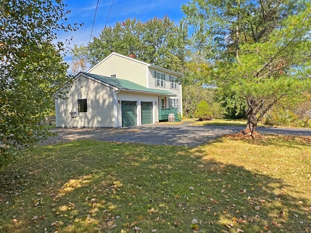 exterior space with a garage and a yard