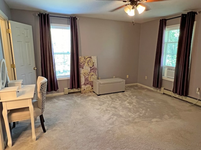 interior space featuring a baseboard heating unit, ceiling fan, and light colored carpet