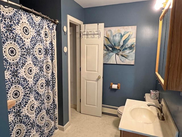 bathroom with baseboard heating, vanity, and toilet