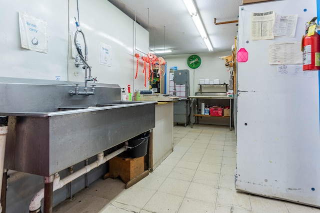 kitchen with white refrigerator and sink