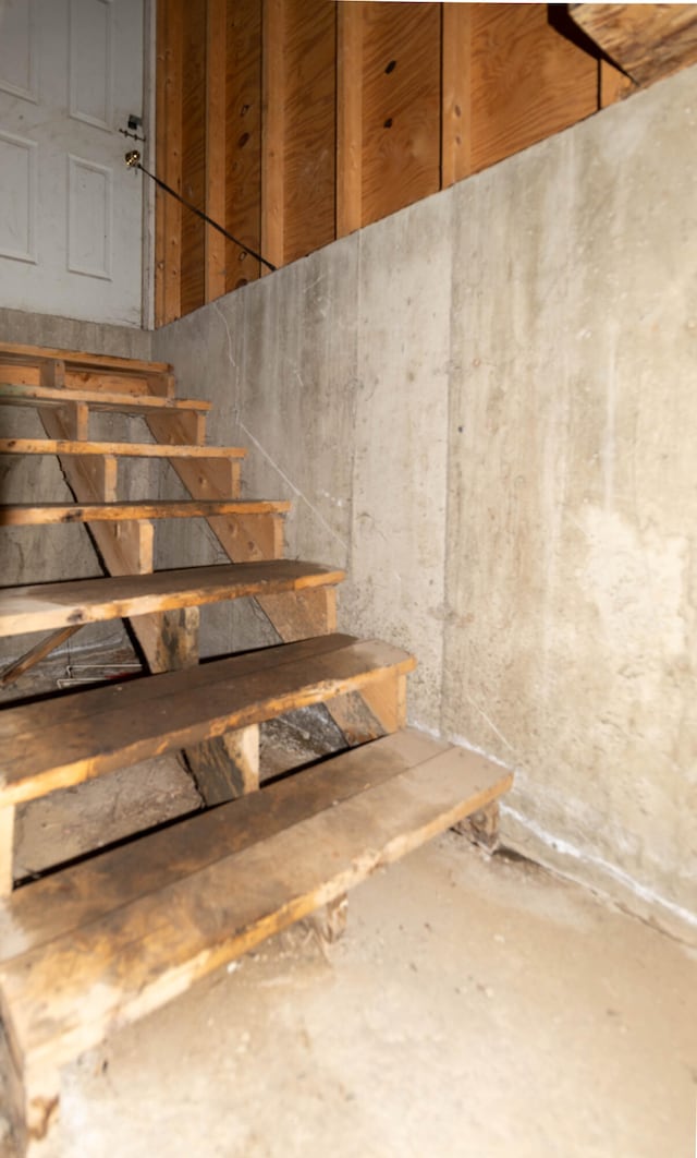 staircase with concrete floors