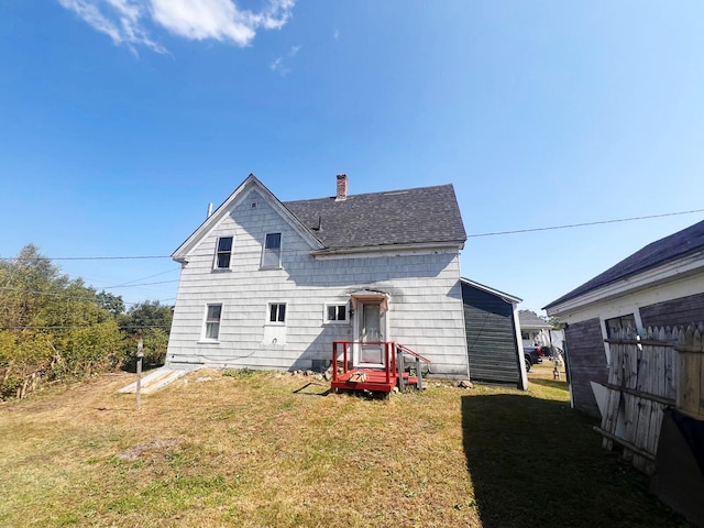 rear view of house with a yard