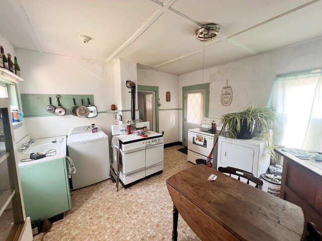 kitchen with white range and washer / dryer