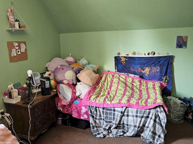 carpeted bedroom with lofted ceiling