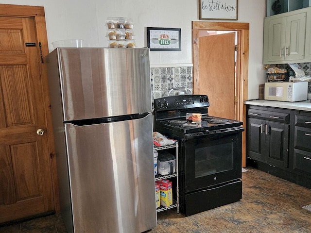 kitchen with decorative backsplash, black range with electric stovetop, and stainless steel refrigerator