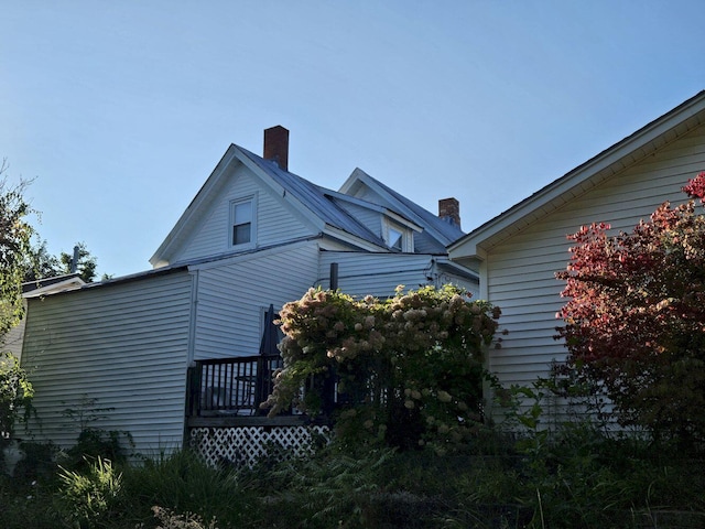 view of property exterior with a deck