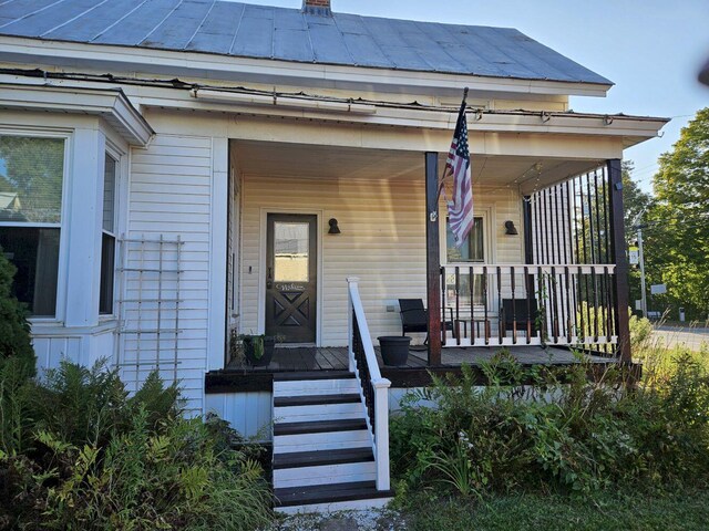 view of exterior entry featuring a porch