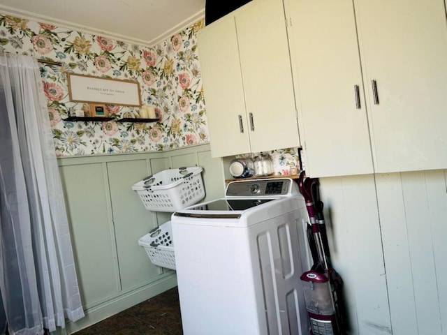 clothes washing area with washer / clothes dryer, cabinets, and crown molding