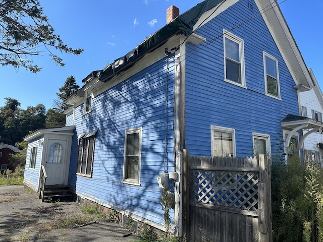 29 Carey Ln, Waterville, ME 04901 - view of property exterior featuring a chimney and entry steps