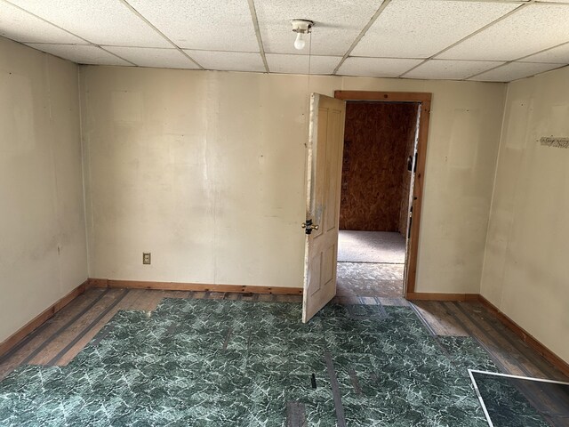 29 Carey Ln, Waterville, ME 04901 - spare room featuring a drop ceiling, baseboards, and wood finished floors