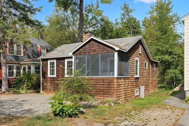 view of home's exterior featuring a sunroom