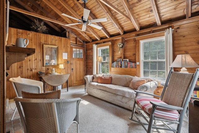 living room with a healthy amount of sunlight, wooden walls, and ceiling fan