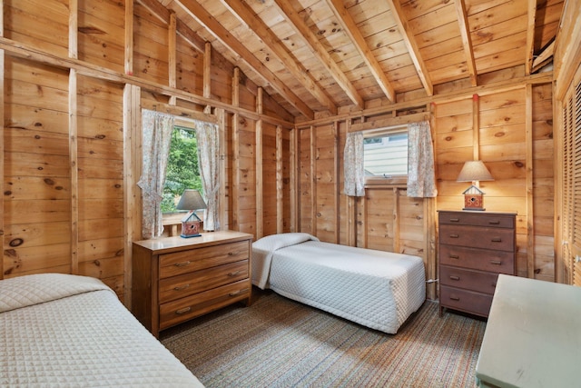 bedroom featuring lofted ceiling with beams, wood walls, and wooden ceiling