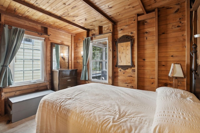 bedroom featuring wood walls, multiple windows, and wooden ceiling